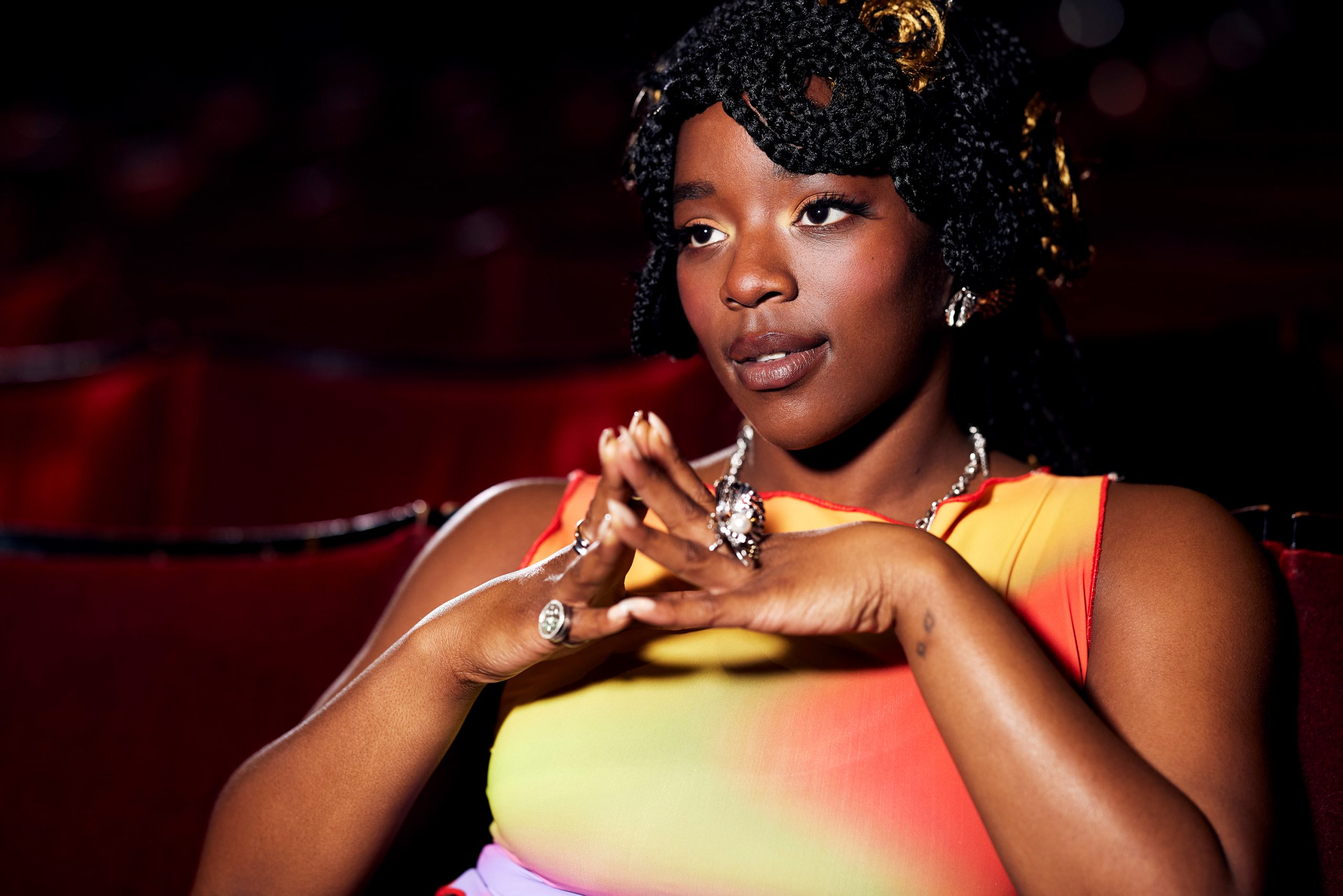Corrina sitting with her hands together in the theatre