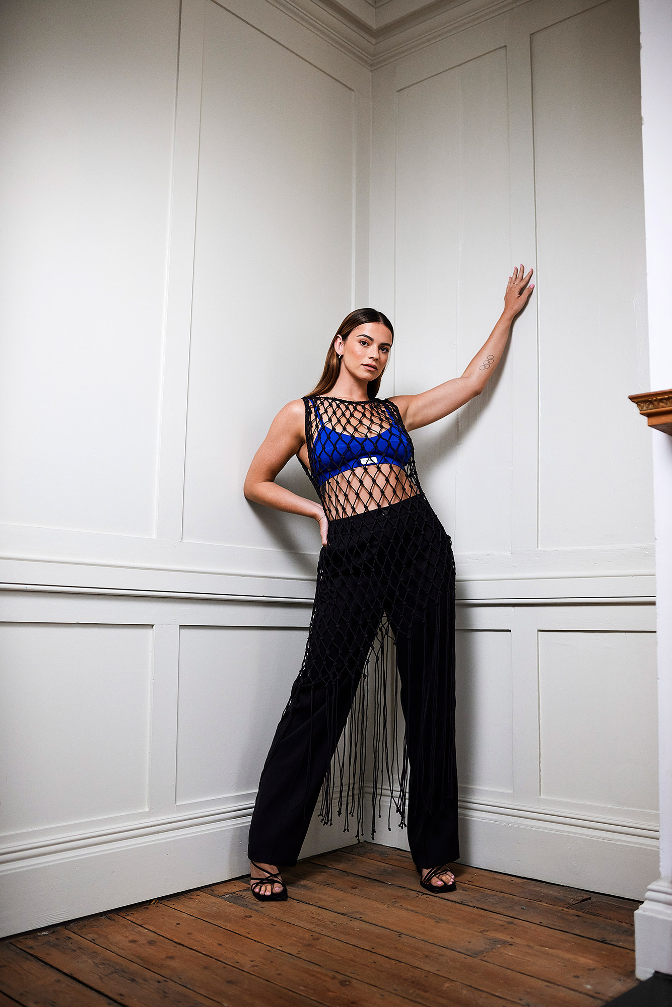 Skye leaning against the corner of two walls