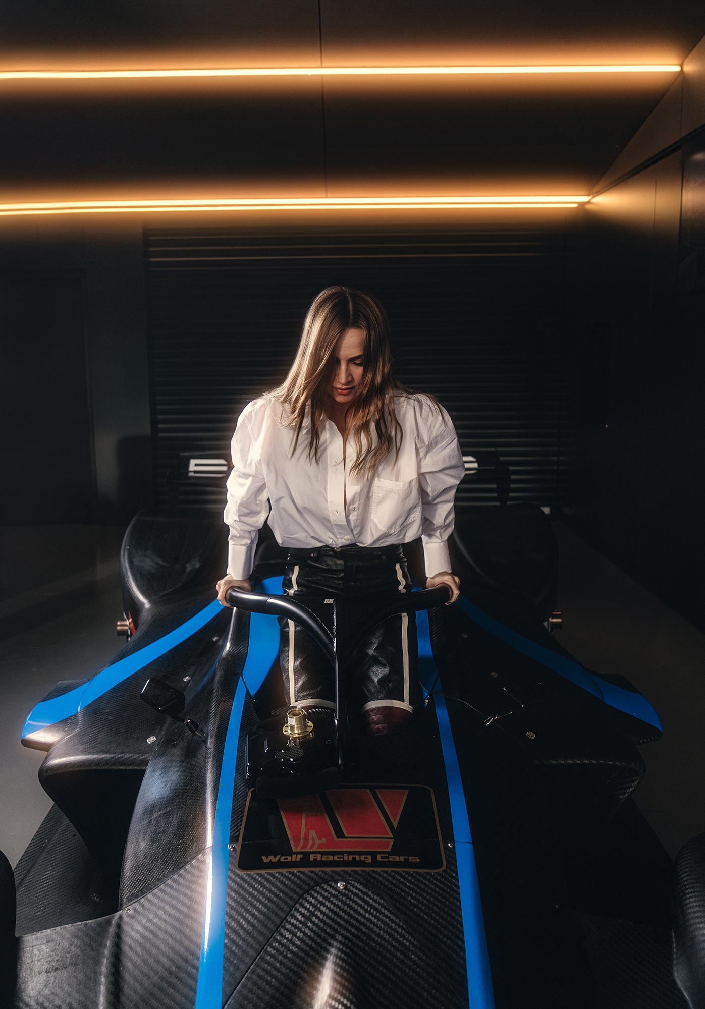 Carmen getting out of an open cockpit race car