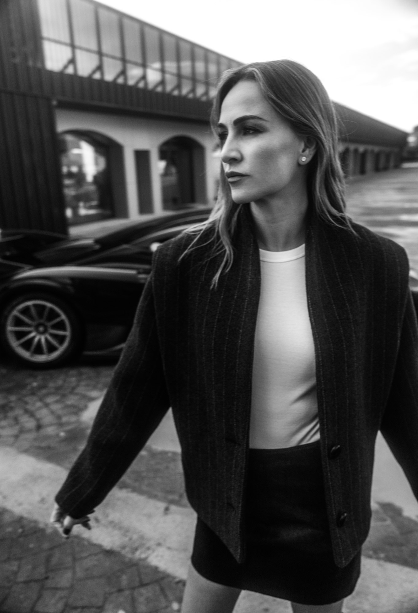 Carmen standing in front of a supercar