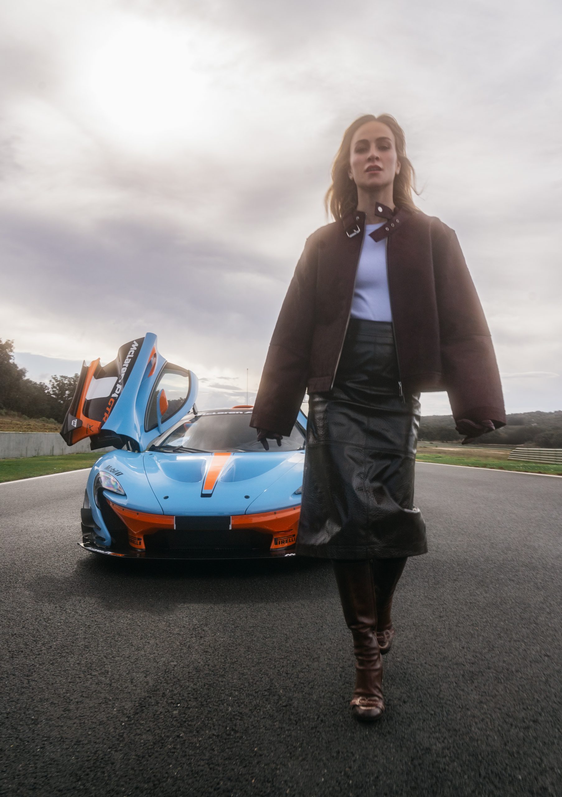 Carmen walking away from a supercar