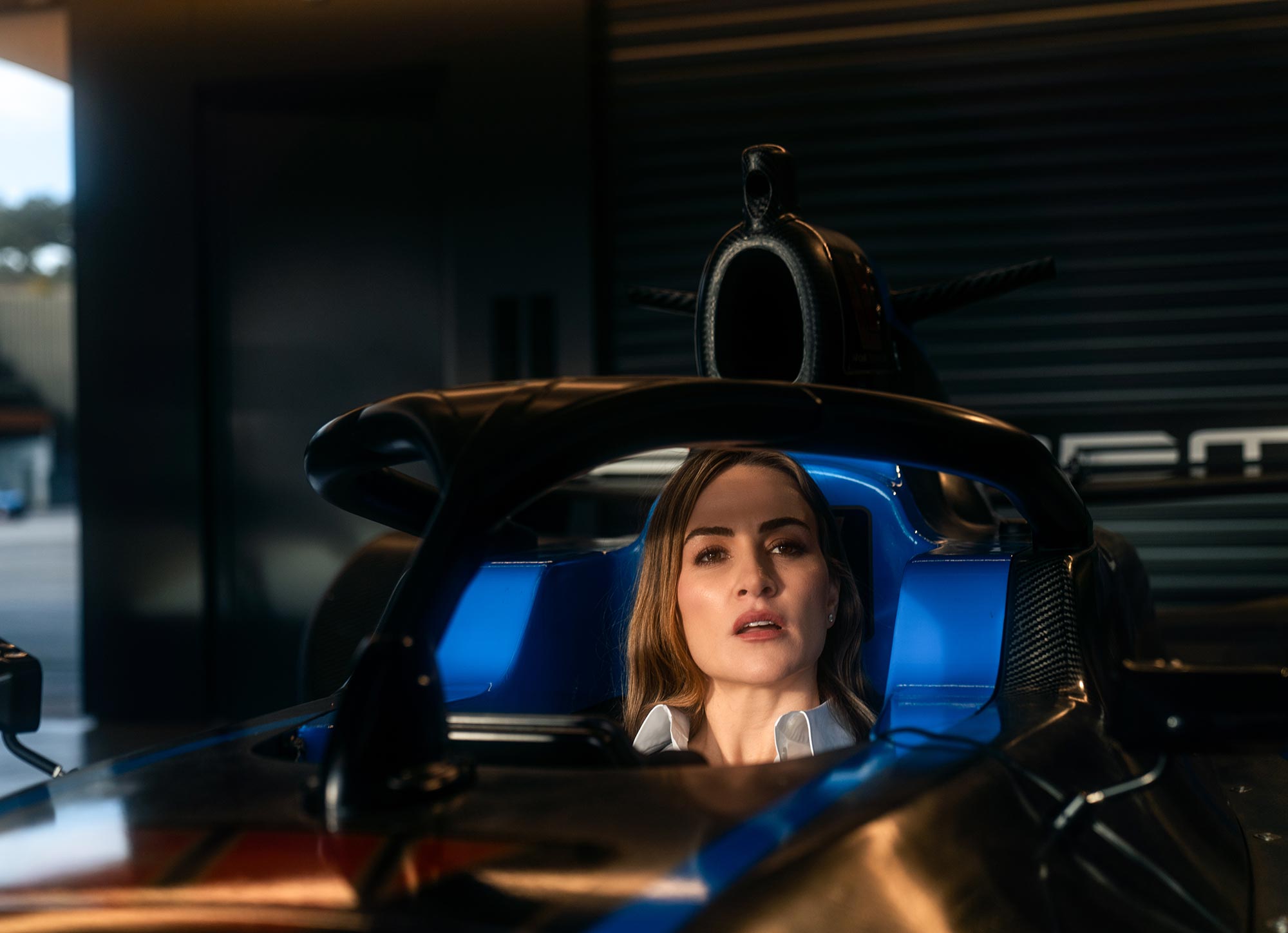 Carmen sitting in an open air race car