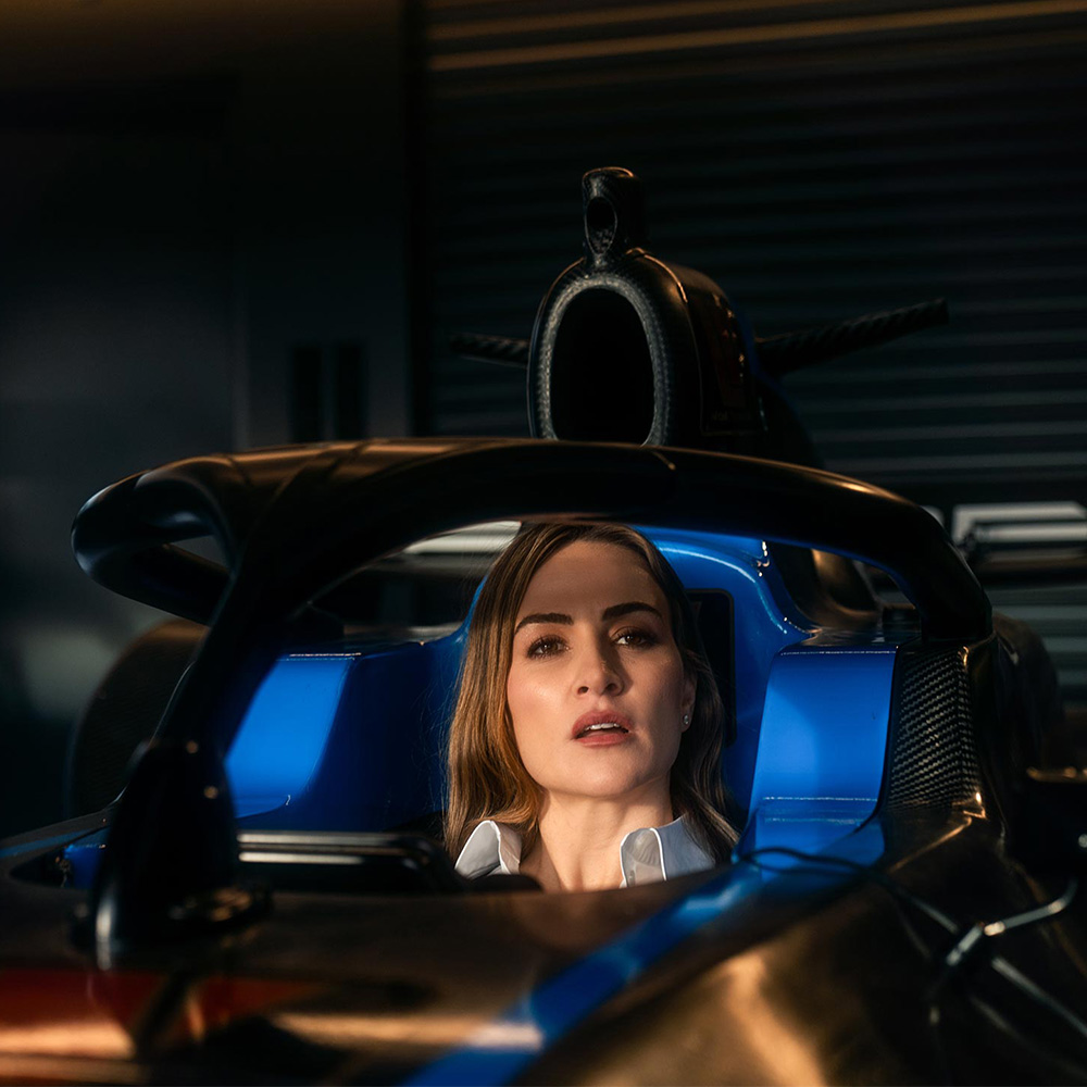 Carmen sitting in an open cockpit car