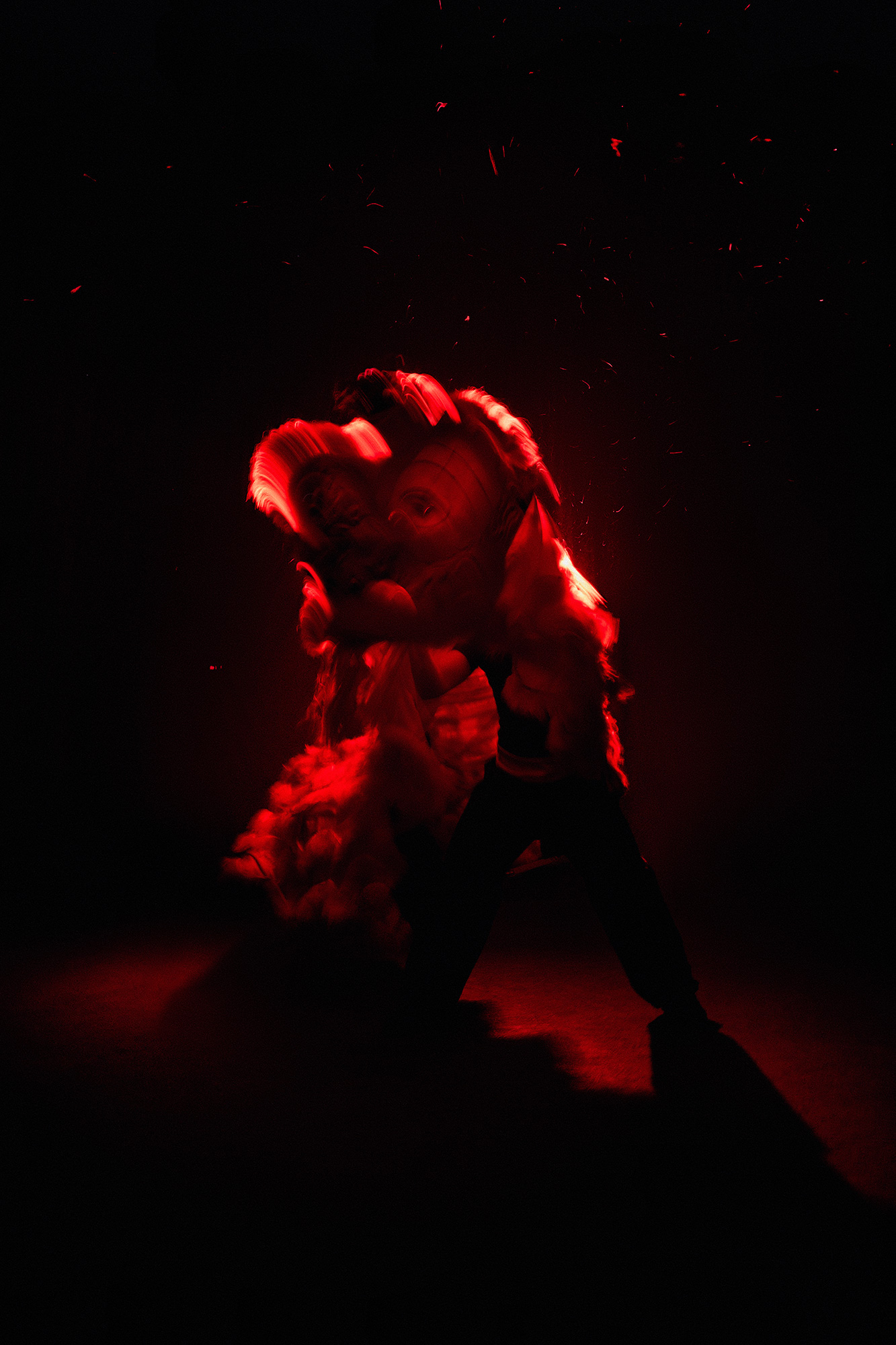 A human silhouette getting into a large model of a lion for Chinese New Year