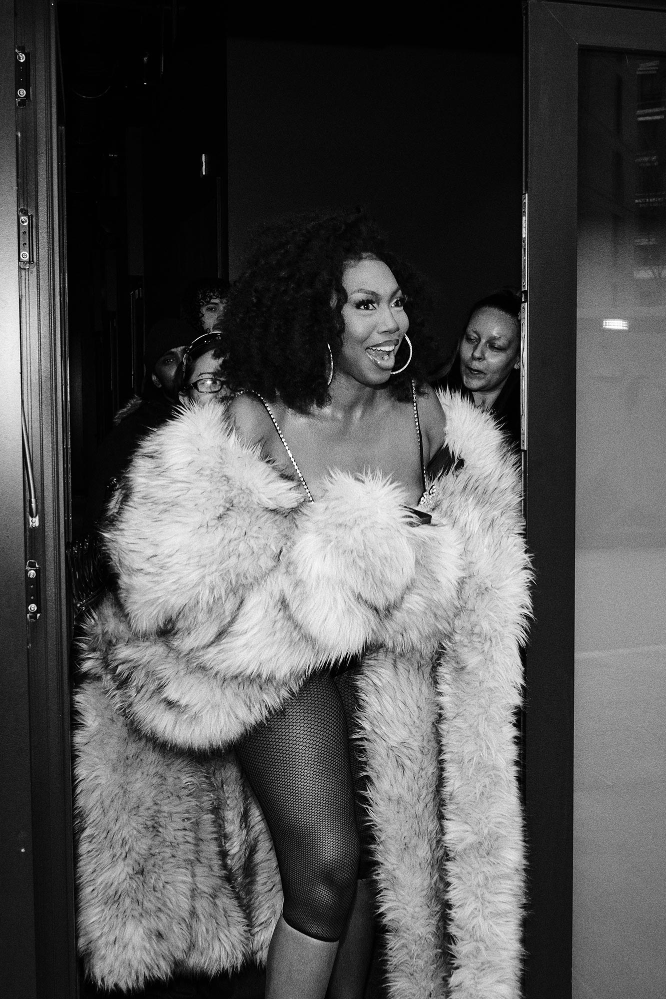 Ms Banks laughing whilst wearing a fur coat