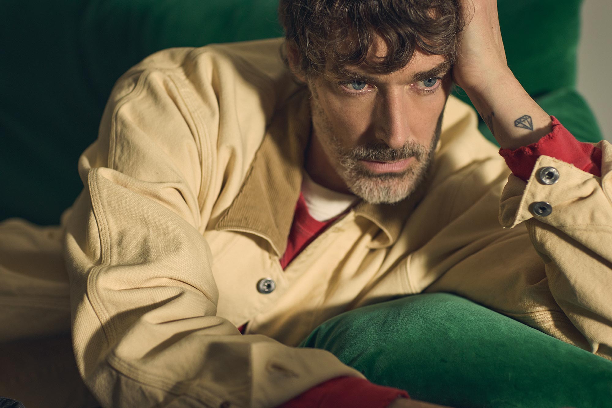 Richard laying on a sofa looking towards the floor