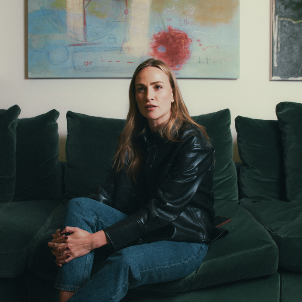 Carmen sitting on a green sofa